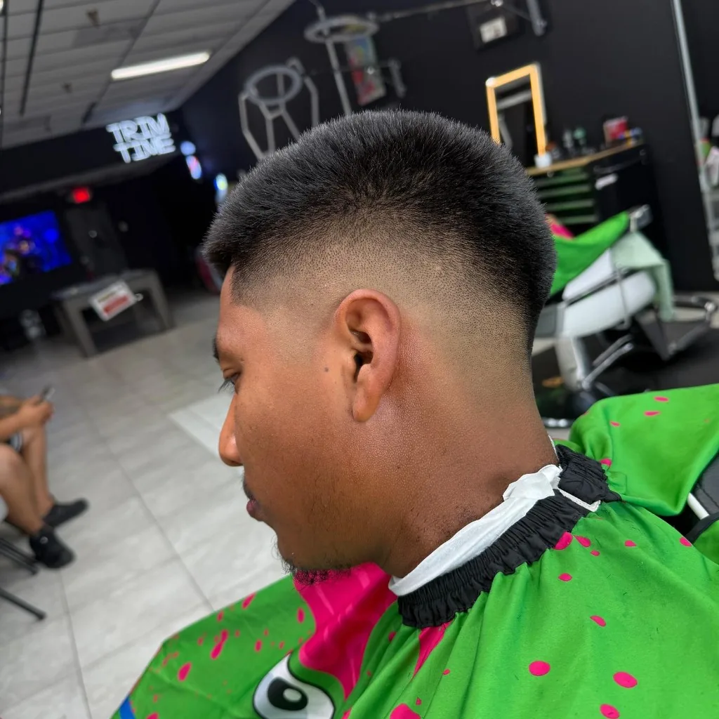 Mid skin fade profile with TRIM TIME neon in the Ellenton shop